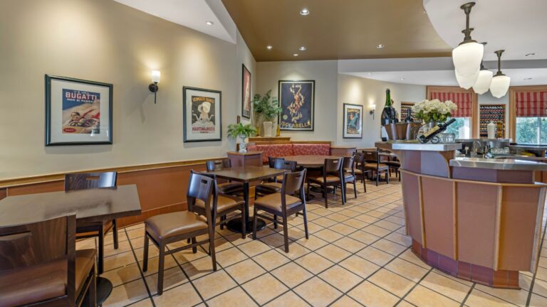 Cozy dining room inside the hotel restaurant with wall art and upholstered seating.